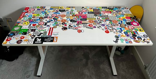 Top down view of a desk with stickers all over it